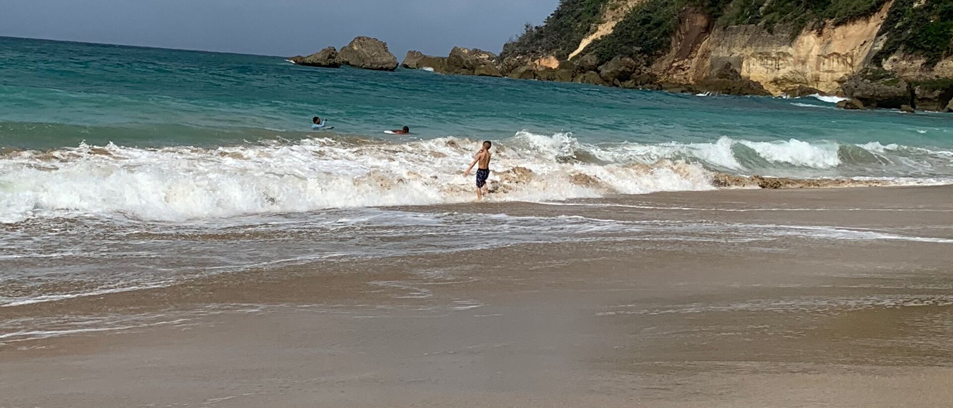 The family in the surf on a Puerto Rico beach